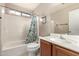 Bathroom featuring a white tub-shower combination, neutral walls, and wood-look vanity at 13159 W Caribbean Ln, Surprise, AZ 85379