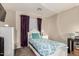 Cozy bedroom featuring a white bed frame, a fluffy accent pillow, and a bright window at 13159 W Caribbean Ln, Surprise, AZ 85379