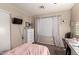 Bedroom with a dresser, desk, and curtains, providing a comfortable and functional space at 13159 W Caribbean Ln, Surprise, AZ 85379