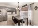 Bright dining area with a rustic table and bench seating, adjacent to living spaces at 13159 W Caribbean Ln, Surprise, AZ 85379