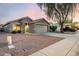 Attractive single-Gathering home with desert landscaping, a two-car garage, and a mature shade tree at 13159 W Caribbean Ln, Surprise, AZ 85379