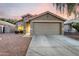 Charming single-story home featuring a two-car garage and well-maintained desert landscaping at 13159 W Caribbean Ln, Surprise, AZ 85379
