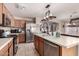 Well-lit kitchen featuring wooden cabinetry, stainless steel appliances, and a functional center island at 13159 W Caribbean Ln, Surprise, AZ 85379