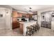 Well-equipped kitchen features wooden cabinets, a breakfast bar, and stainless steel appliances at 13159 W Caribbean Ln, Surprise, AZ 85379