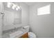 Well-lit bathroom features granite countertops, modern fixtures, and a white toilet and door at 13261 W Gelding W Cir, Surprise, AZ 85379