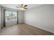 Neutral bedroom features a large window letting in natural light, complemented by wood-look floors at 13261 W Gelding W Cir, Surprise, AZ 85379