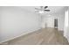 Bright bedroom featuring a ceiling fan, wood-look flooring, and ample space at 13261 W Gelding W Cir, Surprise, AZ 85379