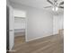Bright bedroom featuring a ceiling fan, wood-look flooring, and a walk-in closet at 13261 W Gelding W Cir, Surprise, AZ 85379