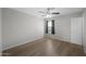 Bright bedroom with wood-look floors and large windows, plus a ceiling fan for comfort at 13261 W Gelding W Cir, Surprise, AZ 85379