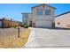 Desirable two-story home featuring a wide driveway, a two-car garage, and desert-style landscaping, blending functionality and style at 13261 W Gelding W Cir, Surprise, AZ 85379