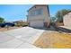 Two-story home showcasing a wide driveway, a two-car garage, and desert-friendly landscaping, offering practical appeal at 13261 W Gelding W Cir, Surprise, AZ 85379