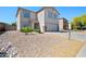 Attractive two-story home with desert landscaping, complemented by a paved driveway, exuding modern suburban charm at 13261 W Gelding W Cir, Surprise, AZ 85379