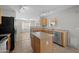 Kitchen featuring wooden cabinets, stainless steel appliances, tile floors, and a center island at 13261 W Gelding W Cir, Surprise, AZ 85379