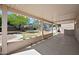 Spacious covered patio, offering a tranquil view of the beautifully landscaped backyard at 13261 W Gelding W Cir, Surprise, AZ 85379