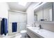 Clean bathroom with a glass-enclosed shower, white vanity, and neutral color scheme at 14300 W Bell Rd # 222, Surprise, AZ 85374