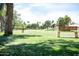 Serene park featuring mature trees, open green space, and comfortable bench seating at 14300 W Bell Rd # 222, Surprise, AZ 85374
