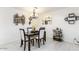 Formal dining area with modern chandelier, wine rack art, and convenient bar cart for seamless entertaining at 14300 W Bell Rd # 222, Surprise, AZ 85374