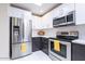 Well-equipped kitchen with stainless steel appliances and stylish cabinetry under a bright skylight at 14300 W Bell Rd # 222, Surprise, AZ 85374