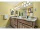 Bathroom with double sink vanity, granite countertop, and updated lighting at 145 N 74Th St # 240, Mesa, AZ 85207