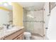 Bright bathroom featuring granite countertop vanity and glass shower with neutral tile and pebble floor at 145 N 74Th St # 240, Mesa, AZ 85207