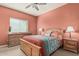 Comfortable bedroom with neutral carpet, wood furniture, and a window with natural light at 145 N 74Th St # 240, Mesa, AZ 85207