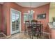 Dining area with table, chairs, and patio access through a glass door at 145 N 74Th St # 240, Mesa, AZ 85207
