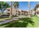 Exterior view of apartments with green grass, mature shade trees and sidewalk at 145 N 74Th St # 240, Mesa, AZ 85207