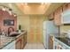 Bright kitchen with granite countertops, black sink, and wood cabinets at 145 N 74Th St # 240, Mesa, AZ 85207