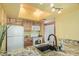 Bright kitchen featuring granite counters, black sink and wood cabinets at 145 N 74Th St # 240, Mesa, AZ 85207