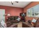 Relaxing living room featuring leather furniture, a flat-screen TV, and a light-filled window at 145 N 74Th St # 240, Mesa, AZ 85207
