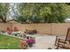 This backyard features a picnic table and lounge chairs alongside potted plants lining the wall at 15140 W Glenrosa Ave, Goodyear, AZ 85395
