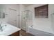Bright bathroom with double sinks, separate shower, and a bathtub by the window at 15140 W Glenrosa Ave, Goodyear, AZ 85395