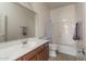 Bathroom with a spacious countertop, mirror, tiled floor, and a shower with a bathtub at 15140 W Glenrosa Ave, Goodyear, AZ 85395
