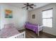 Bright bedroom with two twin beds and a window; a comfortable space for relaxation and rest at 15140 W Glenrosa Ave, Goodyear, AZ 85395