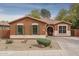 Charming single-story home with a desert landscape, a tile roof, and decorative shutters at 15140 W Glenrosa Ave, Goodyear, AZ 85395