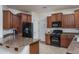 Modern kitchen with dark appliances, stylish cabinets, and a breakfast bar area at 15140 W Glenrosa Ave, Goodyear, AZ 85395