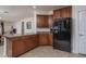 Corner kitchen featuring granite countertops, cabinet space, and tile floors at 15140 W Glenrosa Ave, Goodyear, AZ 85395