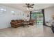 Inviting living room with plush seating, a ceiling fan, and access to the backyard at 15140 W Glenrosa Ave, Goodyear, AZ 85395