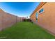 The backyard has a well-manicured lawn and a privacy fence at 16600 W Washington St, Goodyear, AZ 85338