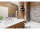 Bathroom featuring a large vanity with a white countertop and dark wood cabinets at 16600 W Washington St, Goodyear, AZ 85338