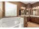 Bright bathroom with soaking tub, dual sinks, and plenty of counter space and natural light at 16600 W Washington St, Goodyear, AZ 85338
