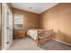 Bedroom with neutral carpet, one window, and a wooden bed frame at 16600 W Washington St, Goodyear, AZ 85338