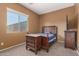 Bedroom with neutral carpet, one window, and a wooden bed frame at 16600 W Washington St, Goodyear, AZ 85338