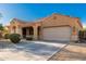 Charming single-story home featuring a well-manicured front yard, a two-car garage, and a covered front porch at 16600 W Washington St, Goodyear, AZ 85338