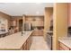 Well-equipped kitchen featuring tile floors, stainless steel appliances, granite counters, and island seating at 16600 W Washington St, Goodyear, AZ 85338
