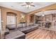 Open-concept living room featuring hardwood floors, modern decor, and seamless flow into the kitchen at 16600 W Washington St, Goodyear, AZ 85338