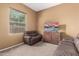 Living room featuring two leather couches, a tv and a window at 16600 W Washington St, Goodyear, AZ 85338