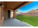 Covered patio provides a comfortable outdoor space with views of the lush backyard at 16600 W Washington St, Goodyear, AZ 85338