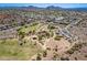Expansive aerial shot of a neighborhood park with playgrounds, picnic areas, a sand volleyball court, and green spaces at 1811 E Tierra Buena Ln, Phoenix, AZ 85022