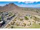 Scenic view overlooking a community park with tennis courts, a playground, and walking paths against a backdrop of mountains at 1811 E Tierra Buena Ln, Phoenix, AZ 85022
